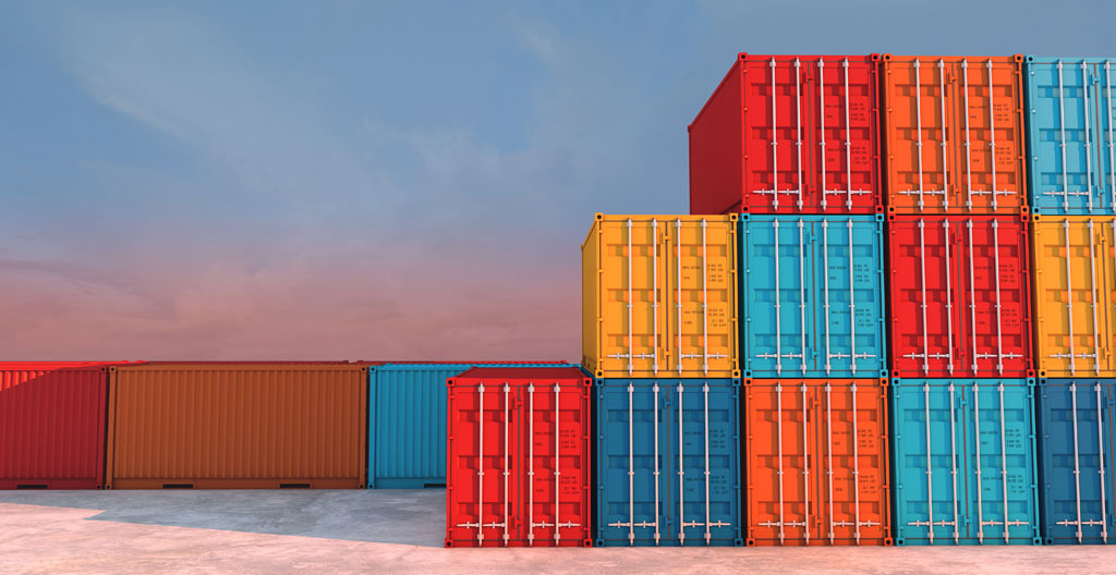 Interior of an open shipping container showing pallets of different building material products stacked at varying heights